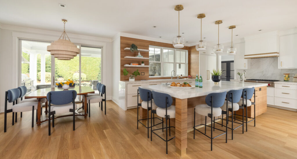 Modern kitchen with rift white oak cabinetry and brass-accented island by JWH Design